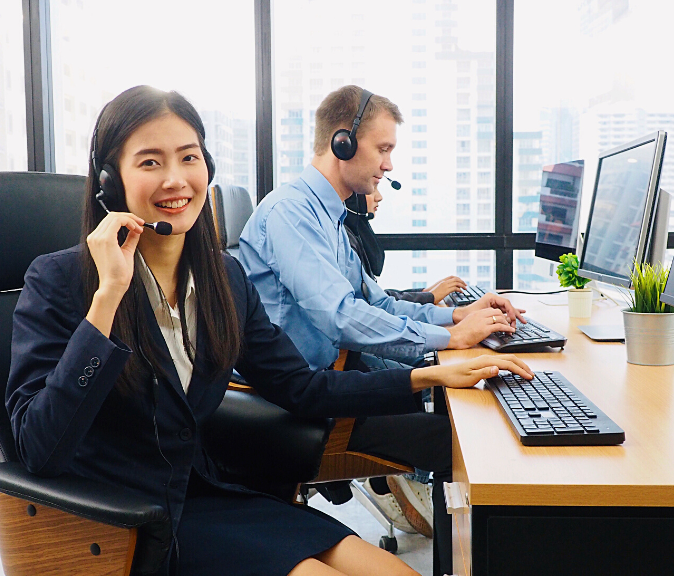 Outstanding IT Support Services From Sydney Managed IT Smiling IT support staff in the office with his colleagues taking client calls